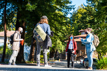 Student and parent with masks on hugging