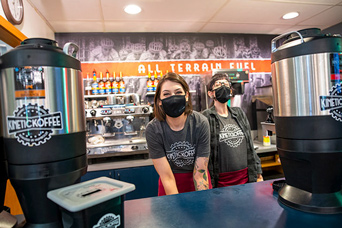 two students working at a Kinetic Coffee stand