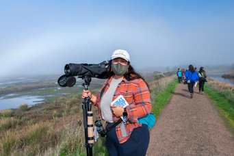 a student holding a camera on the arcata marsh trail