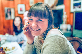 Jacqueline Themel smiling at the camera with hand on her face