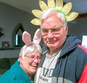 Pattie and Glen Atkinson wearing headbands of bunny ears and a flower