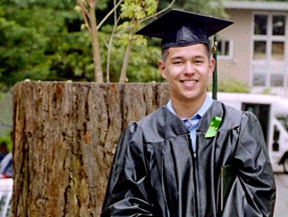 Photo of Braden wearing a graduation cap and gown