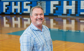 Dan Phillips standing in a gymnasium