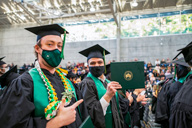 Students at commencement with masks on